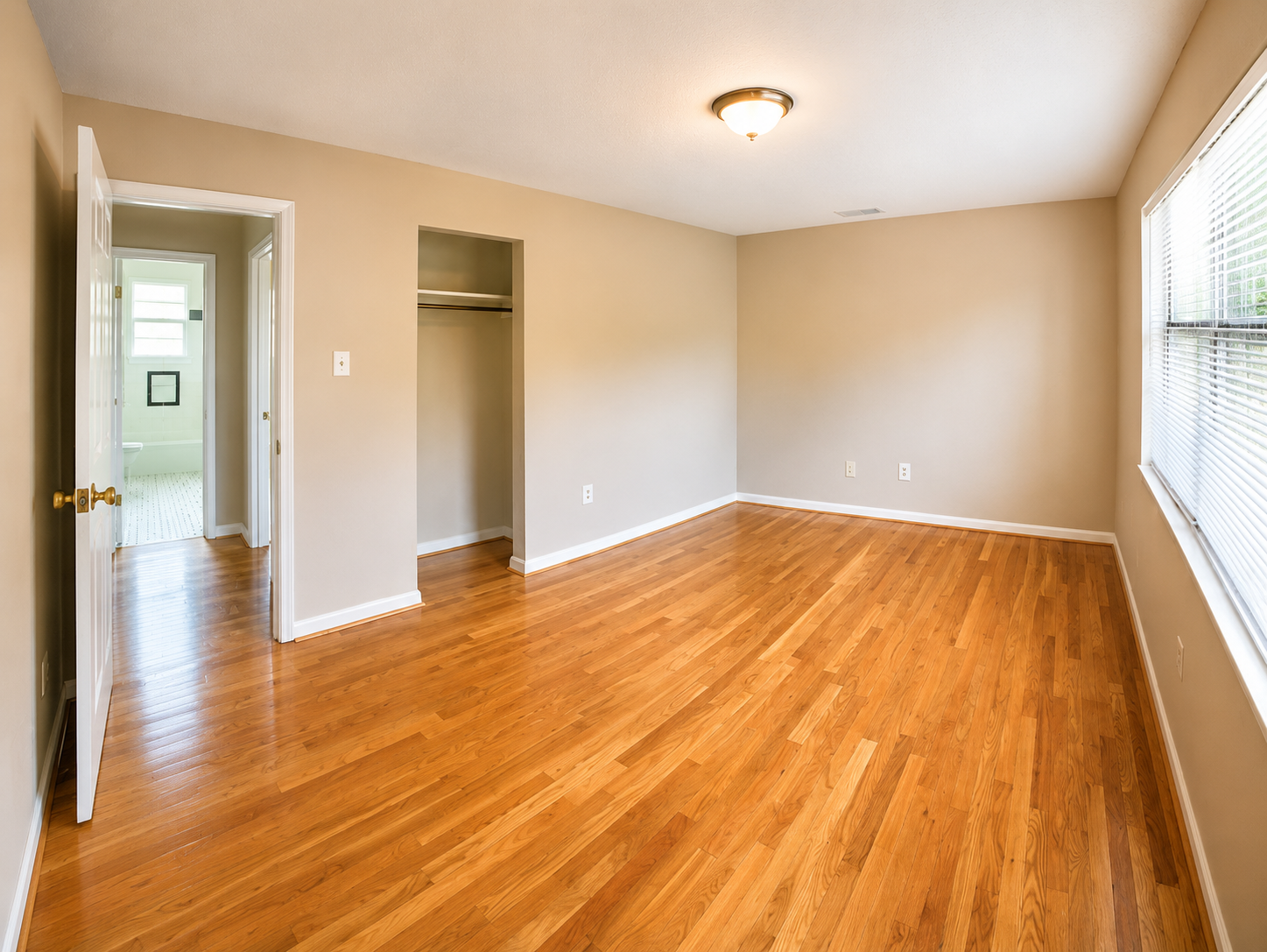 Urban Star Apartments second bedroom with closet and hardwood floors